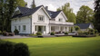 © darkhairedblond - Exterior of a suburban home with blue siding, a white front porch, and white shutters.