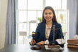 © MrAshi - A young Asian female lawyer who works with contracts on laptops in justice law firms and courtroom legal concepts on wooden tables and counsel or legal counsel, justice advice and concepts.