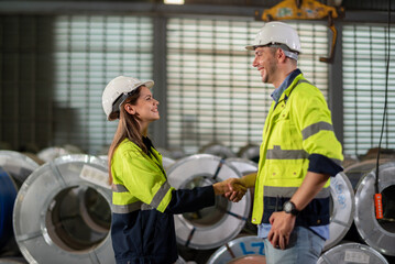 Factory apprenticeship. Man mentor teaching Female employees trainee operating machine looking monitors and check Production process machinery. foreman explaining woman engineer control machine .