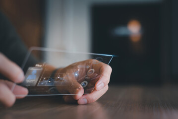 a close-up of a man's hand grasping the idea of a transparent phone being used to obtain data via a visual chart app.