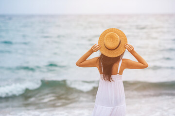 Wall Mural - Happy woman enjoying beautiful sunset on the beach