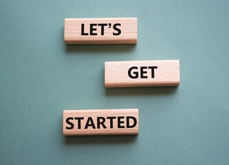 Wall Mural - lets get started symbol. concept words lets get started on wooden blocks. beautiful grey green backg