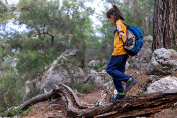 Wall Mural - Earth day concept. happy boy explores summer forest, travels on vacation. Teach children to love nature.