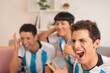 Friends shouting while watching penalties of an argentina match