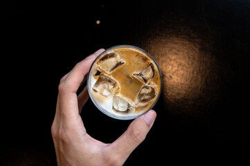 Sticker - Iced coffee with milk in a glass on a table in a cafe