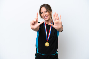 Wall Mural - Young caucasian woman with medals isolated on white background counting seven with fingers