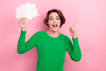 Photo of young surprised funny woman hold bubble cloud genius idea eureka point finger up decision isolated on pink color background