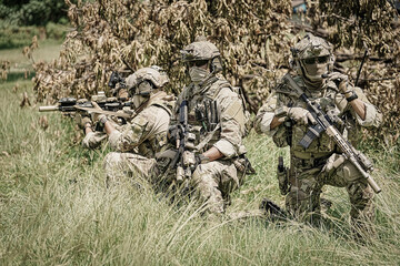 United States Army ranger during the military operation. Professional marine soldiers training with weapon on a military range.