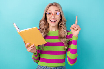 Poster - Portrait of pleasant clever girl with wavy hairdo wear stylish clothes hold book find excellent thought isolated on blue color background