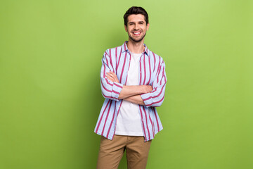 Photo of successful young ceo executive director folded arms confident happy smile high income company isolated on green color background