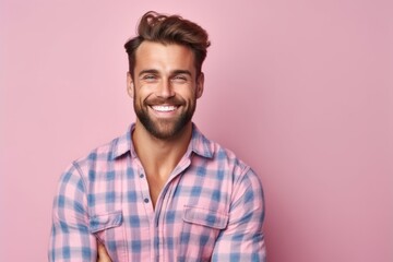 Wall Mural - Portrait of handsome young man in checkered shirt on pink background