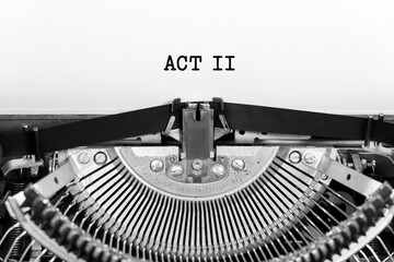 Act two word closeup being typing and centered on a sheet of paper on old vintage typewriter mechanical