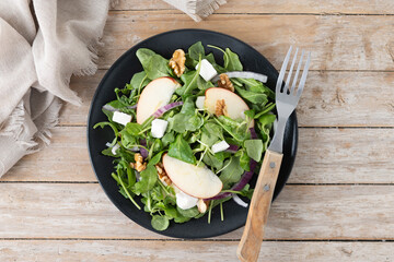 Poster - Autumn salad with apples and walnuts on wooden table. Top view
