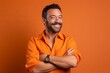 © igolaizola - Portrait of a smiling handsome man in orange shirt on orange background