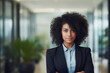 © ant - Young professional business woman standing and smile in blur office background.