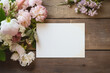 Blank paper and flowers on country rustic wooden table background for printable art, paper, stationery and greeting card mockup