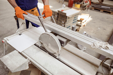 Wall Mural - Male worker using sawing machine in workshop