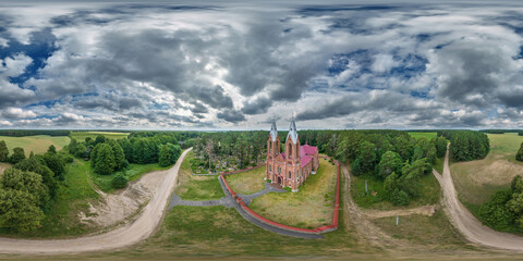 Wall Mural - full hdri 360 panorama aerial view on red brick neo gothic catholic church in countryside or village in equirectangular projection with zenith and nadir. VR  AR content