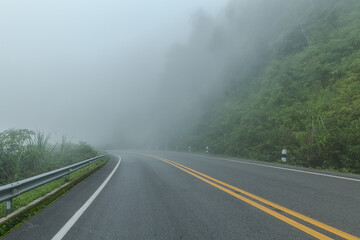 Wall Mural - Beautiful asphalt road in the foggy.