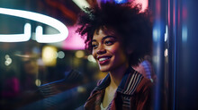 Portrait Of Young Beautiful Black Woman On City Street At Night. Neon Lights And Glass Reflection. 