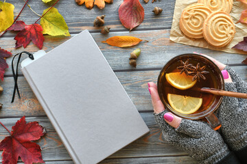 Autumn book cover mock up flat lay with female holding spiced hot tea or apple cider