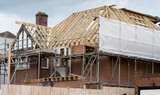 Fototapeta Londyn - Europe, UK, England, Surrey, scaffolding on house roof renovation