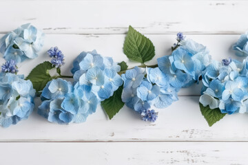 Wall Mural - beautiful and delicate blue flowers arrangement on white wooden background