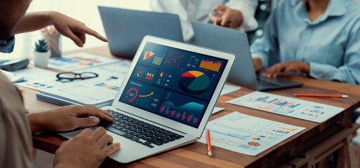 Fototapete - Panorama shot analyst team utilizing BI Fintech to analyze financial report with laptop. Businesspeople analyzing BI power dashboard displayed on laptop screen for business insight. Scrutinize