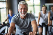 © bluebeat76 - Portrait of senior man training on stationary bike workout in gym. Concept senior active lifestyle. Generative Ai