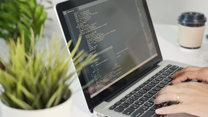 Programmer woman writing program HTML code sitting at workplace in office, IT software developer hands typing data coding programming with laptop computer, IT start up concept, Web application design