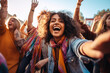 © MVProductions - Epitomizing youth and fun. A diverse, energetic group of millennials dancing with joy and excitement at a lively music festival, with bright colors
