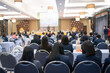 © EduLife Photos - Rear view of businessperson participating in a business seminar in the hall