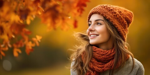  happy woman wearing a cozy clothes against an autumn foliage background