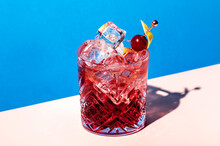 Sbagliato Rosa Alcoholic Cocktail Drink With Italian Red Liqueur And Aperitif, Champagne Rose Or Sparkling Wine, Decorated With Zest, Summer Blue Bright Background, Hard Light And Shadows