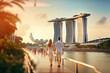 © Rytis - Young couple traveling and walking in Singapore. City in background. Man and woman view from behind. Sunset summer background. Generative AI