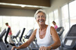 © AI_images - mature senior woman at gym. AI Generated