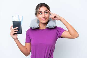 Wall Mural - Young pretty Uruguayan woman with Inflatable Travel Pillow isolated on white background having doubts and thinking