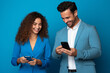 © wolfhound911 - woman and man with phone on blue background . AI Generated