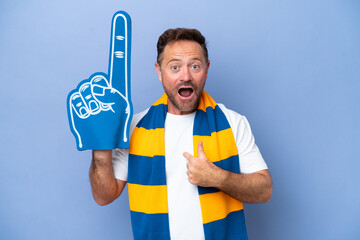 Wall Mural - Middle age caucasian sports fan man isolated on blue background with surprise facial expression