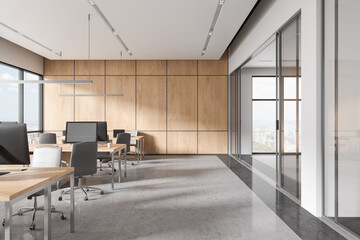 White coworking interior with armchairs and computers in row, glass doors