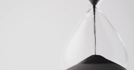 Sticker - Video of hourglass with sand pouring, copy space on white background