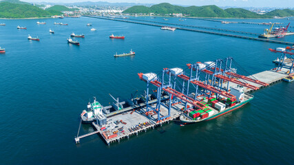 Cargo container Ship running on Bridge Cargo Shipyard. Container ship under the crane Sea Port service logistics and transportation. International Shipping Depot Customs Port for import export trading