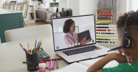 Sticker - African american schoolboy having laptop video call with female teacher in slow motion