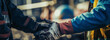 © FATHOM - Blue collar workers shake hands with work gloves on - Generative Ai