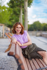 Wall Mural - Beautiful successful middle aged woman posing on the street photo shoot