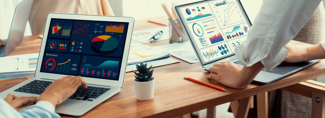Fototapete - Panorama shot analyst team utilizing BI Fintech to analyze financial report with laptop. Businesspeople analyzing BI power dashboard displayed on laptop screen for business insight. Scrutinize