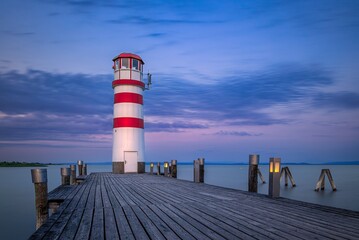 Wall Mural - Podersdorf lighthouse at the end of the pier on the Neusiedler See in Austria at dawn 