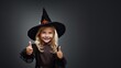 © Анастасия Козырева - Little girl in halloween costume showing thumbs up on dark background.  Generative AI.