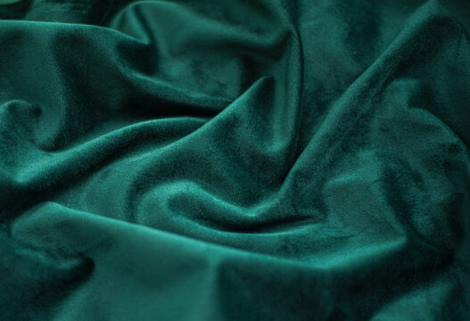 emerald velvet with folds background image, green shiny fabric silk for background web design wallpaper, dark green textile background