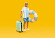 Full body photo of a funny young happy man tourist in rubber ring hurrying up on summer holiday trip in office clothes isolated on studio yellow background. Vacation and travel concept.